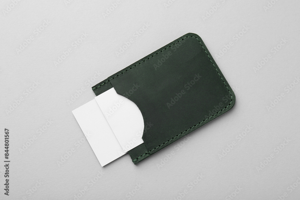 Leather business card holder with blank cards on light grey background, top view Leather business card holder with blank cards on light grey background, top view