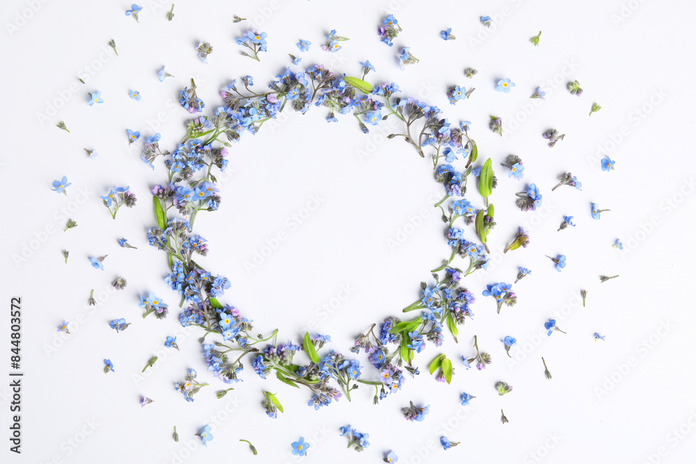 Round frame of beautiful forget-me-not flowers on white background, top view. Space for text Round frame of beautiful forget-me-not flowers on white background, top view. Space for text