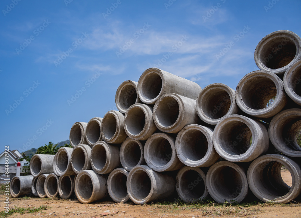 A stack of concrete ring pipes piled and creating a symmetrical arrangement A stack of concrete ring pipes piled and creating a symmetrical arrangement