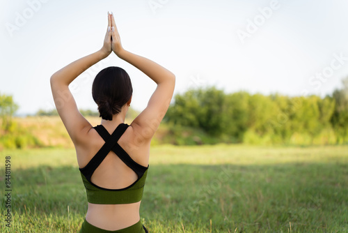 The skill and professionalism of a yoga instructor: a girl practices yoga in a natural location immersed in the world of yoga and nature