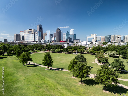 Dallas skyline with Griggs Park greenspace and walking trails and paths under bule sky