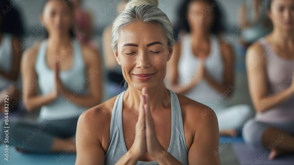 Group of diverse women in sportswear practices yoga in a gym, peaceful and promoting a sense of mindfulness and meditative aspects of yoga practice. Group of diverse women in sportswear practices yoga in a gym, peaceful and promoting a sense of mindfulness and meditative aspects of yoga practice.