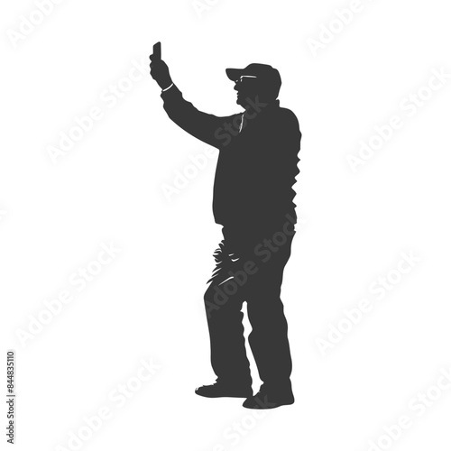 Silhouette of Cap-Wearing Man Holding Phone Aloft Taking a Photo.