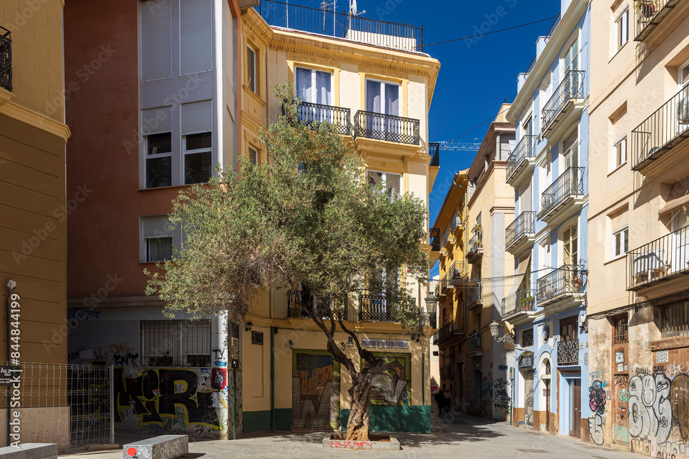 Fototapeta premium VALENCIA, SPAIN - May 2, 2024: Narrow streets with colorful houses in the old town. Street de santa elena valencia