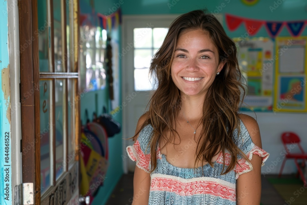 Smiling young woman standing in a colorful classroom Smiling young woman standing in a colorful classroom