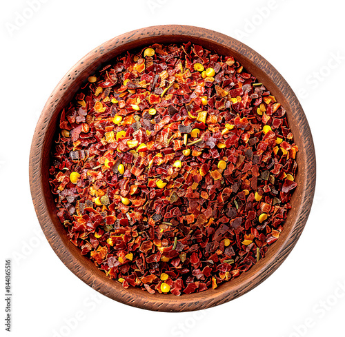 Chili pepper flakes in a rustic wooden bowl, their vibrant red color and irregular shapes showcasing a fiery spice. photo