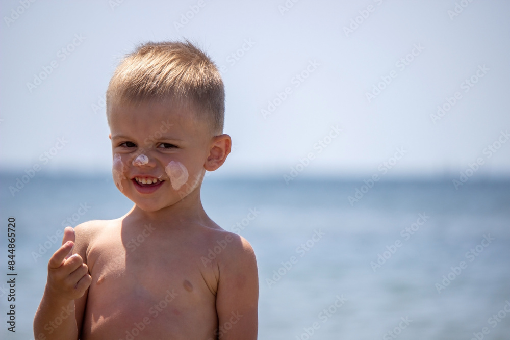 the child applies sun cream on himself. protection from the sun. the child applies sun cream on himself. protection from the sun.