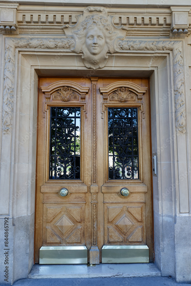Old ornate door in Paris - typical old apartment buildiing. Old ornate door in Paris - typical old apartment buildiing.