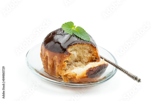 Rum baba decorated with dark chocolate isolated on white