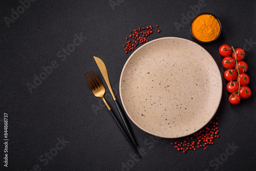 Empty ceramic round plate on dark textured concrete background photo