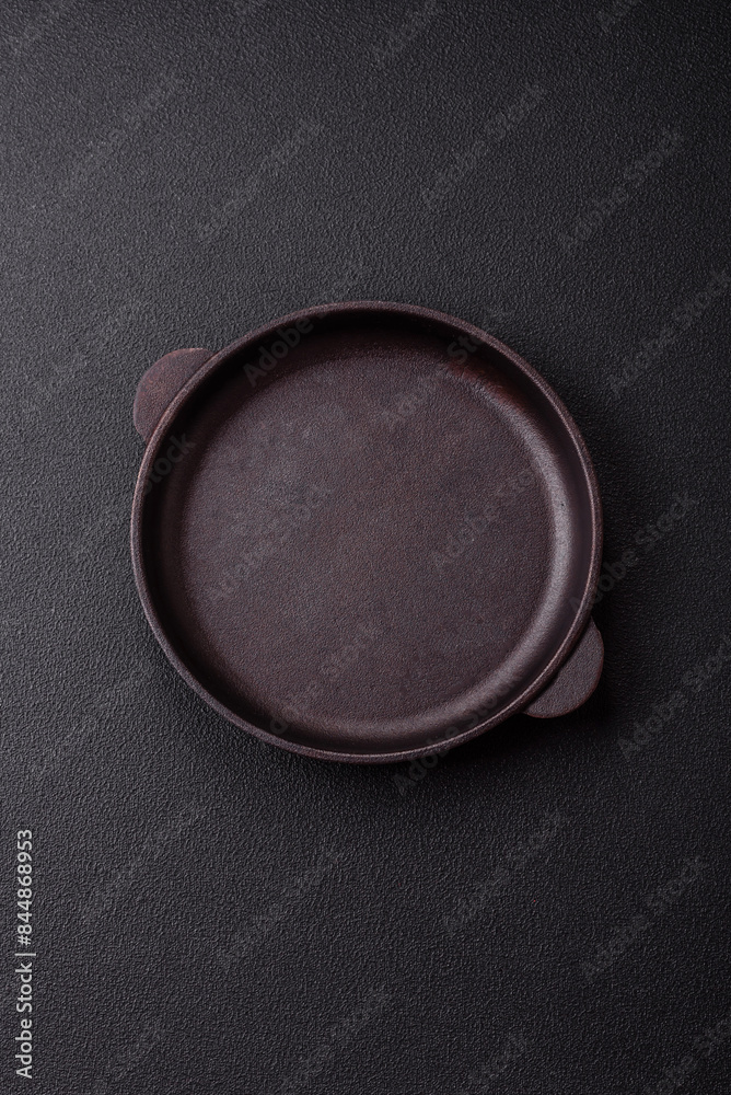 Empty ceramic round plate on dark textured concrete background