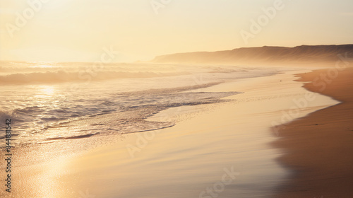 Golden hour at the beach with soft and warm light reflecting off the water and sand sunset sunrise