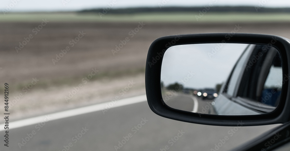 View in the rearview mirror of the car View in the rearview mirror of the car