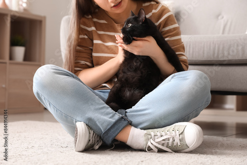Woman with cute black cat s...