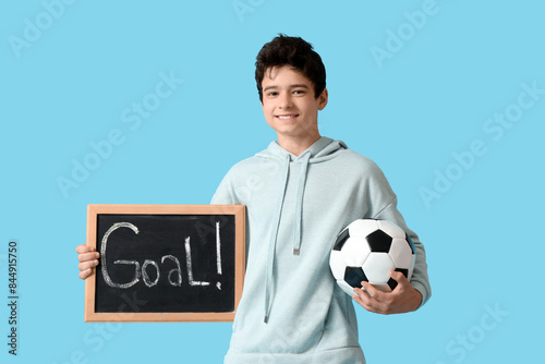 Teenage boy holding soccer ...