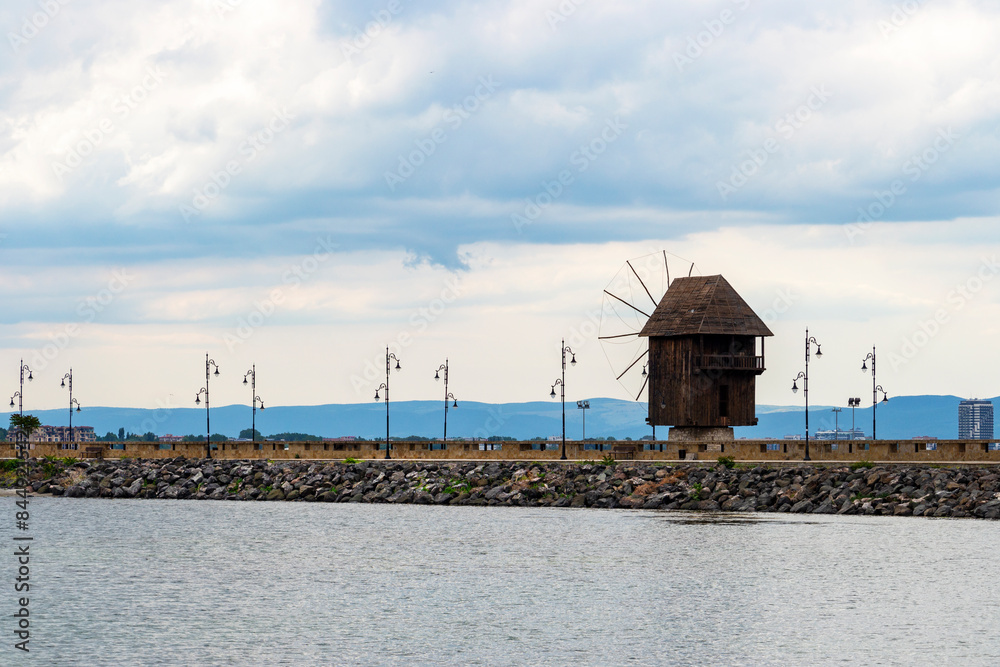 View of the wooden windmill on the promenade before the town entrance of Old Town Nessebar, Burgas Province, Bulgarian Black Sea coast View of the wooden windmill on the promenade before the town entrance of Old Town Nessebar, Burgas Province, Bulgarian Black Sea coast