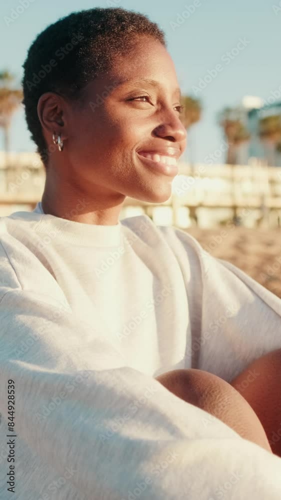 Side view happy girl in light colored casual clothes sitting on the beach Side view happy girl in light colored casual clothes sitting on the beach