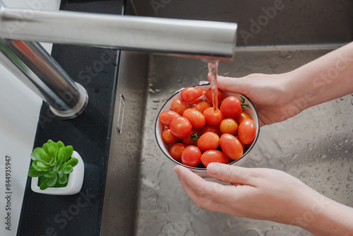 Washing Fresh Cherry Tomatoes in the Kitchen Sink photo