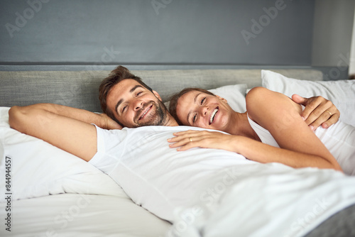 Fotografie Smile, couple and portrait relax on bed in morning, peace or support for marriage commitment at house