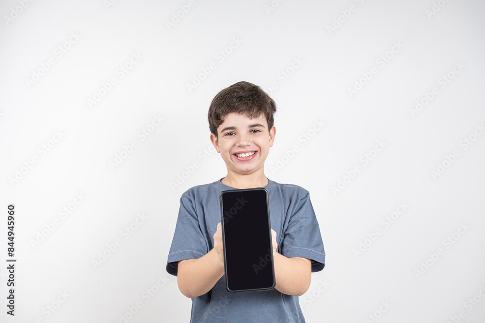 Smiling 10 year old Brazilian child with smartphone in hand_10. Smiling 10 year old Brazilian child with smartphone in hand_10.