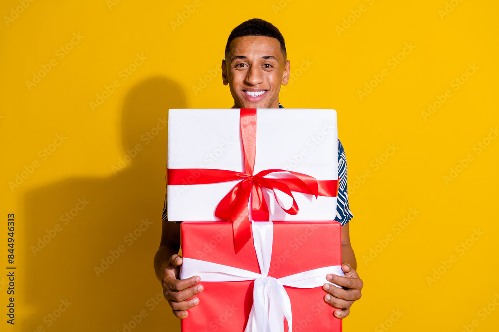 Photo of cheerful positive guy preparing valentine day gift empty space isolated yellow color background Photo of cheerful positive guy preparing valentine day gift empty space isolated yellow color background