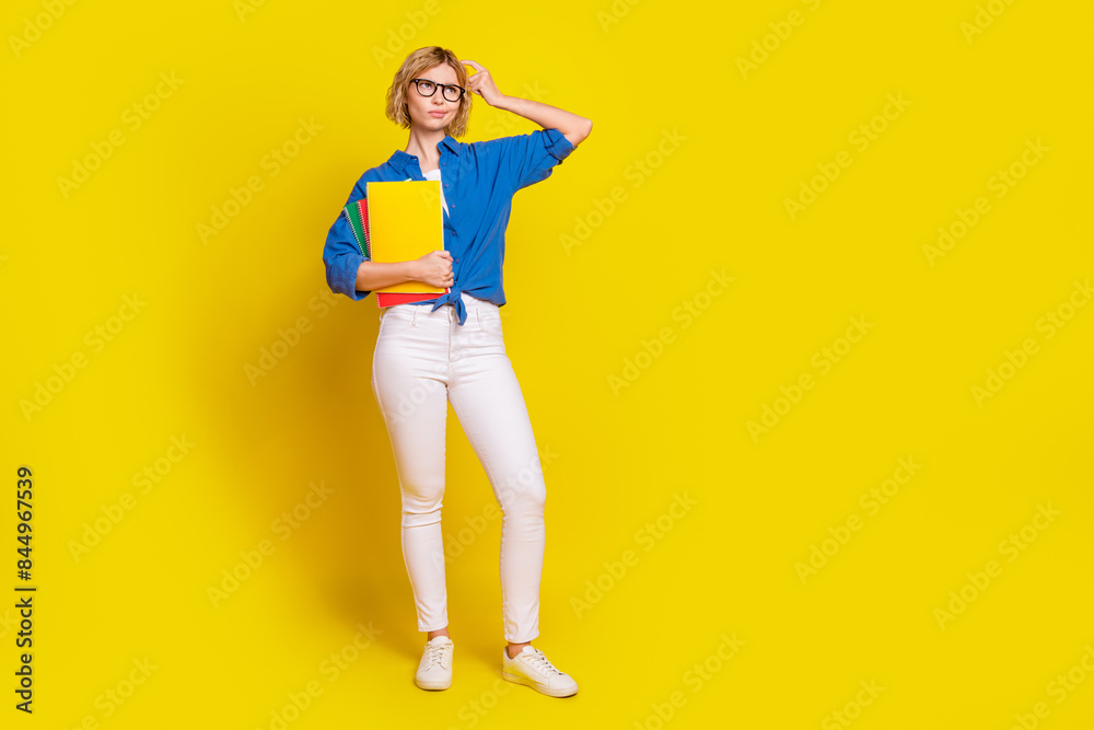Full body portrait of pretty young lady scratch head look empty space wear shirt isolated on yellow color background