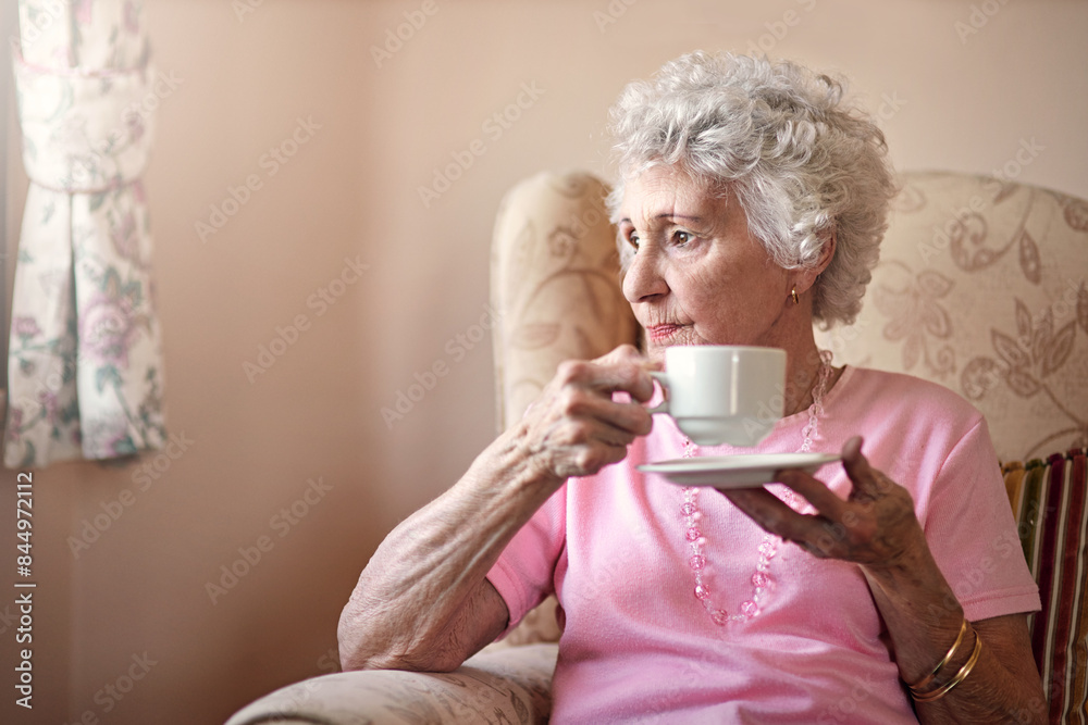 Thinking, tea and senior woman in armchair with health, wellness and comfort in nursing home. Relax, remember and elderly person on sofa in living room with memory, coffee cup and smile in retirement Thinking, tea and senior woman in armchair with health, wellness and comfort in nursing home. Relax, remember and elderly person on sofa in living room with memory, coffee cup and smile in retirement
