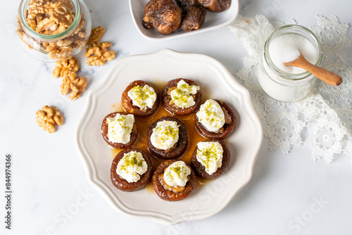 Obraz na płótnie Stuffed dry fig dessert, cooked with syrup, traditional, pistachio and kaymak (Turkish name; kaymakli incir tatlisi ) w salonie