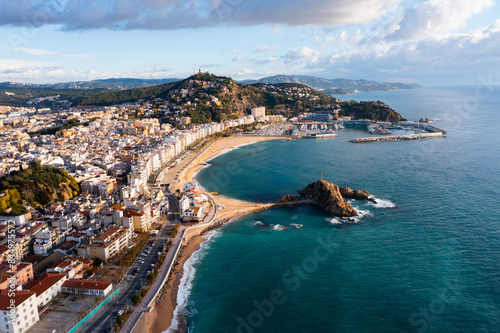 Wallpaper Mural Scenic drone view of coastal Catalan town of Blanes overlooking white residential buildings and Sa Palomera Rock on background of San Juan hill with ancient castle on sunny day, Barcelona, Spain .. Torontodigital.ca