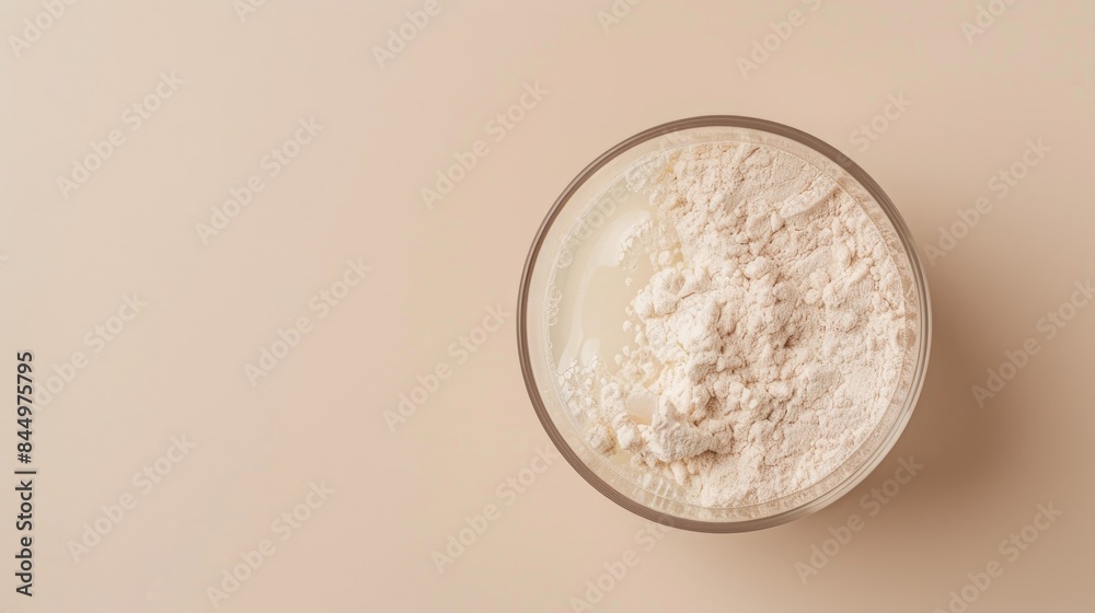 Collagen protein powder mixed in water for skin and bone health on beige background Ample room for text Collagen protein powder mixed in water for skin and bone health on beige background Ample room for text