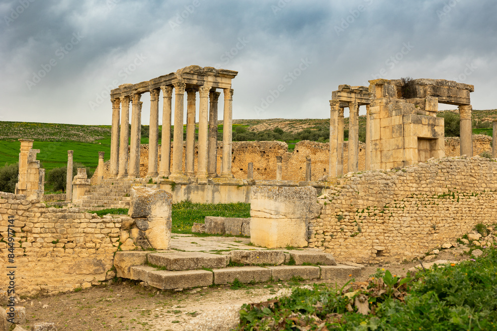 Fototapeta premium View of historical Temple of Juno Caelestis with columns and ruined stone walls in Dougga, Tunisia