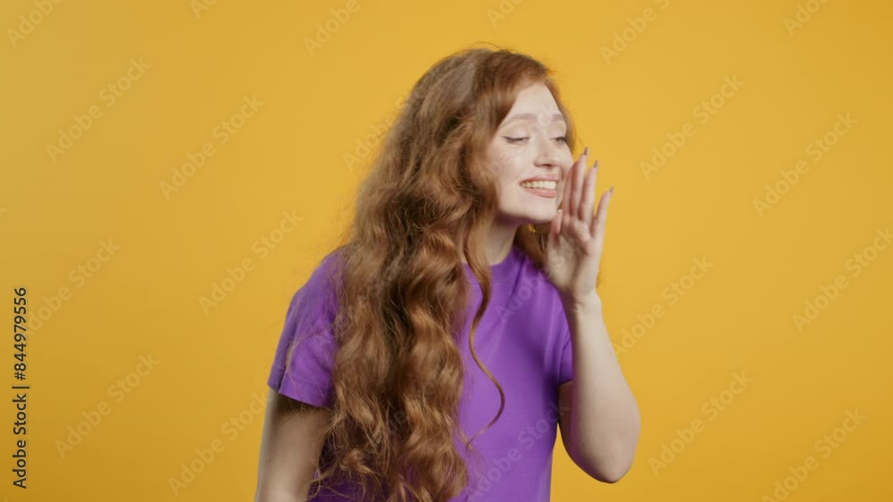 Young load woman calling - Hey you, hello, hi. Waving hand. Greetings on yellow Young load woman calling - Hey you, hello, hi. Waving hand. Greetings on yellow