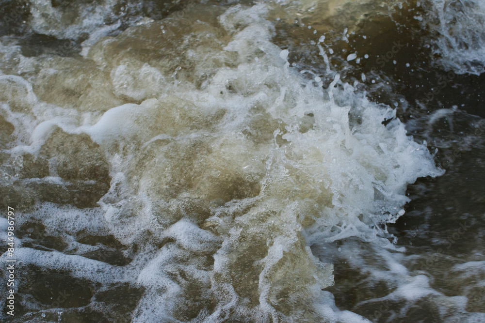 A stormy stream of muddy water. A natural disaster, a flood. A stormy stream of muddy water. A natural disaster, a flood.