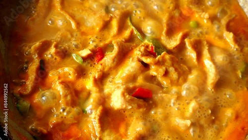 Cooking Panang curry with pork in pan , Thai famous food.
