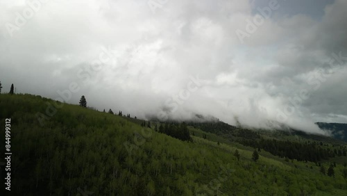 Aerial of dark low clouds in Cache National Forest in northern Utah in springtime near Logan Canyon photo