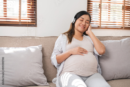 Relaxed Pregnant Woman Sitting on Sofa in Modern Living Room, Listening to Music with Headphone, Enjoying a Peaceful Moment, Expecting Mother in Comfortable Home Environment Free Download Relaxed Pregnant Woman Sitting on Sofa in Modern Living Room, Listening to Music with Headphone, Enjoying a Peaceful Moment, Expecting Mother in Comfortable Home Environment - GFXLoad