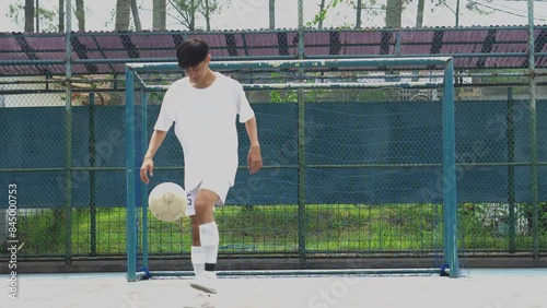 Asian Man Athlete On The Football Field Bounce A Soccer Ball