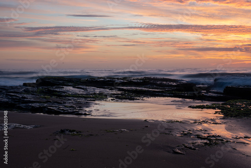 Sunrise over breaking waves beach orange yellow clouds  © Em Neems Photography