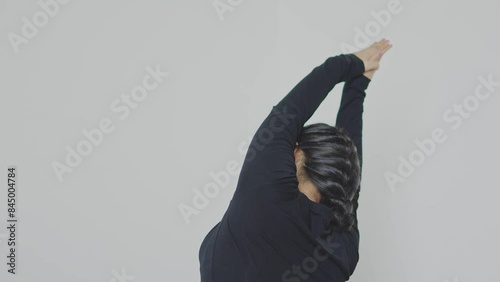 Back View Of Woman Practicing Yoga Lesson Stretching Arms Up