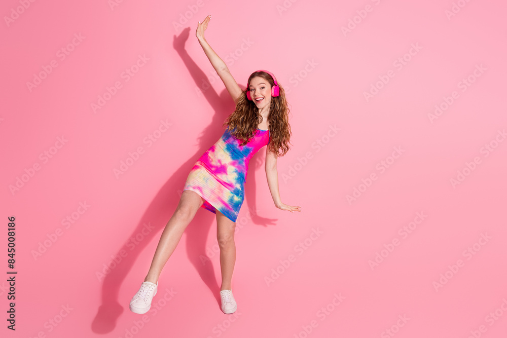 Full length photo of charming positive girl wear retro outfit earphones empty space isolated pink color background Full length photo of charming positive girl wear retro outfit earphones empty space isolated pink color background