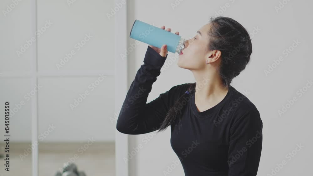 Side View Of Young Asian Woman Drinking Water After Intensive Training Side View Of Young Asian Woman Drinking Water After Intensive Training