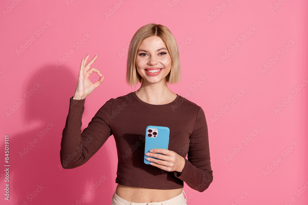Photo of lovely cute girl wear stylish brown clothes okey sign recommendation isolated on pink color background Photo of lovely cute girl wear stylish brown clothes okey sign recommendation isolated on pink color background