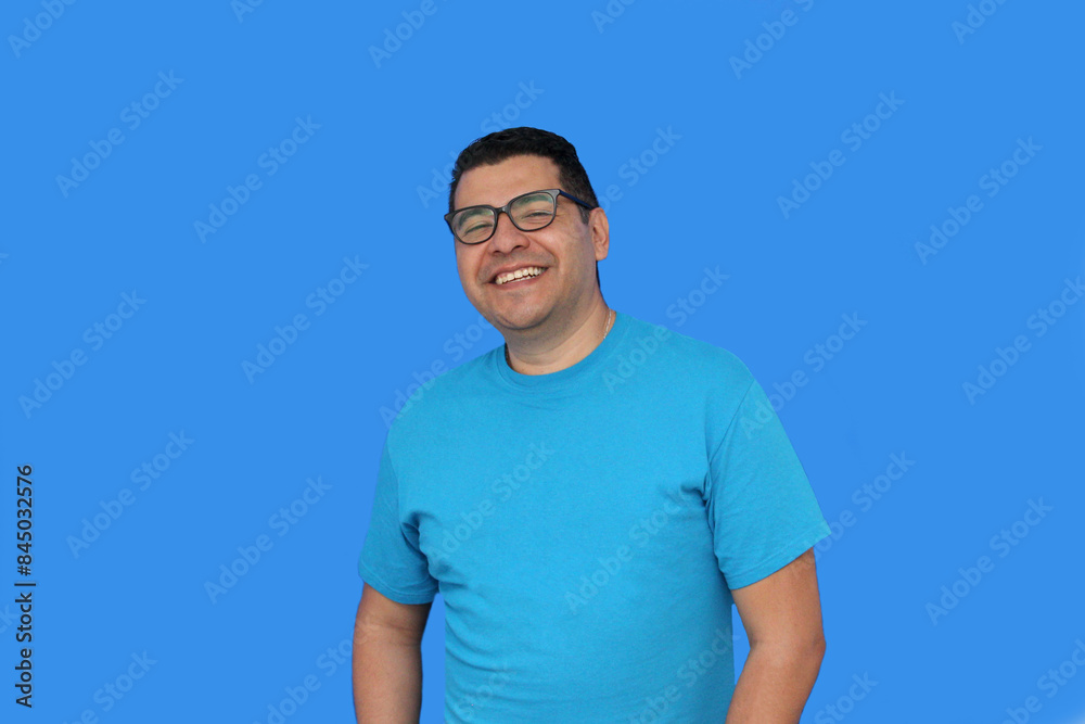 A 40-year-old dark-skinned Latino man uses eyeglasses to see better because he suffers from myopia and astigmatism in the vision of his eyes A 40-year-old dark-skinned Latino man uses eyeglasses to see better because he suffers from myopia and astigmatism in the vision of his eyes