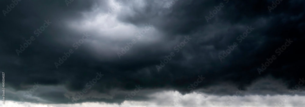 Banner Dramatic dark storm clouds black sky background. Dark thunderstorm clouds rainny season. Panorama Meteorology danger windstorm disasters climate. Dark cloudscape storm cloud with copy space. Banner Dramatic dark storm clouds black sky background. Dark thunderstorm clouds rainny season. Panorama Meteorology danger windstorm disasters climate. Dark cloudscape storm cloud with copy space.
