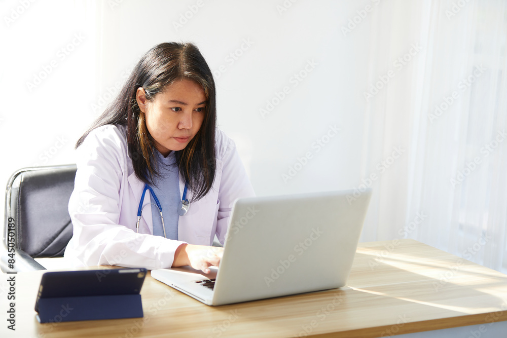 female doctor working on laptop computer in the hospital female doctor working on laptop computer in the hospital