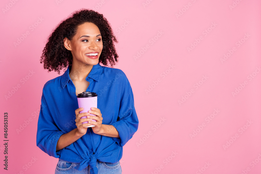 Photo of charming cute woman wear stylish blue clothes hold cup tasty coffee look empty space isolated on pink color background Photo of charming cute woman wear stylish blue clothes hold cup tasty coffee look empty space isolated on pink color background