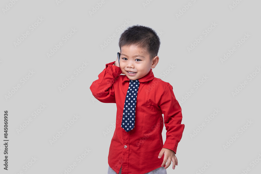 Adorable smiling little boy talking on smartphone isolated on white background. Concept of communication and Mother's Day love family lifestyle. Copy space Adorable smiling little boy talking on smartphone isolated on white background. Concept of communication and Mother's Day love family lifestyle. Copy space