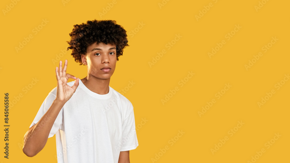 Okay gesture. Positive approval. Confident guy accepting supporting good idea perfect choice isolated on yellow empty space background. Okay gesture. Positive approval. Confident guy accepting supporting good idea perfect choice isolated on yellow empty space background.