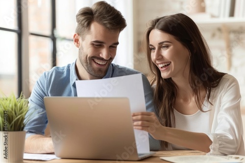 A happy young business woman and male colleagues are working together on laptops in the office, looking at documents. Concept photo, about the passion of a human resources team © SHI