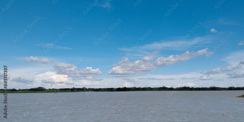 Obraz premium White cumulus clouds in blue sky over sea landscape, big cloud above ocean water panorama, horizon, beautiful tropical sunny summer day seascape panoramic view